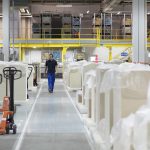 worker walking through paper packaging factory