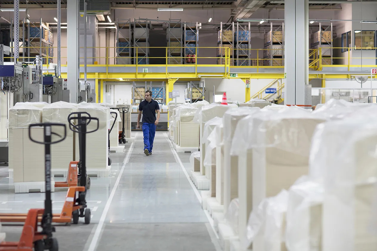 worker walking through paper packaging factory